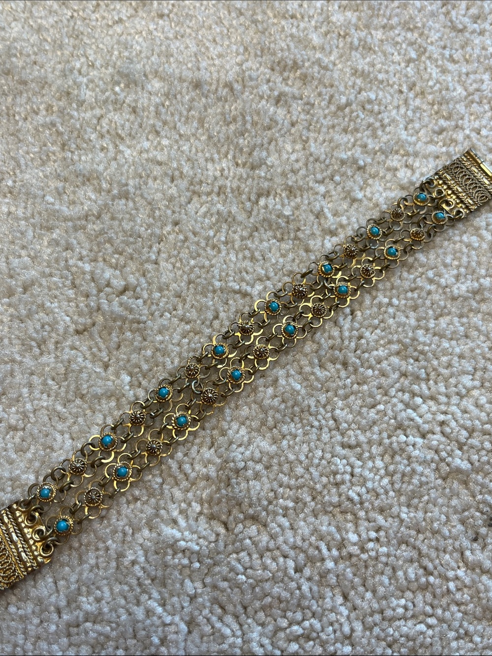 Vintage Greek linked bracelet with turquoise colored stone inset.
